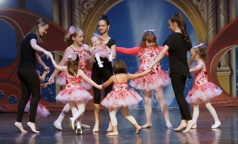 Volunteers help student dancers during A Chance to Dance stage performance