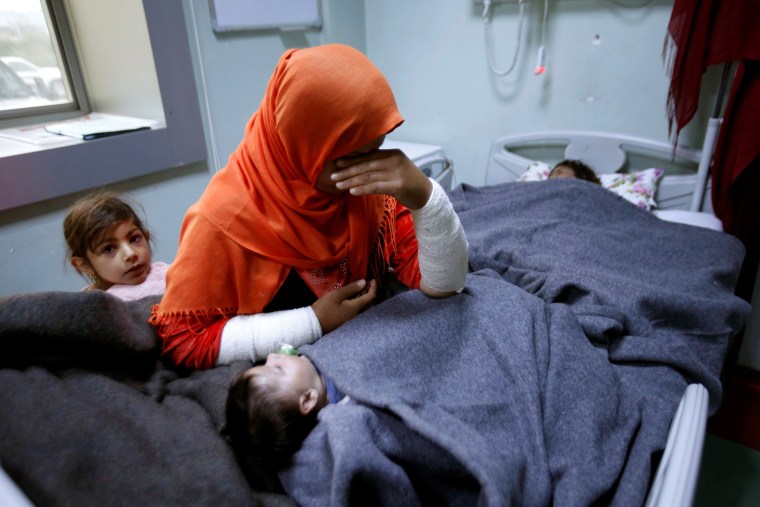 Image: A mother reacts as her daughter Ranmea is treated for possible exposure to chemical weapons agents in a hospital west of Erbil in Mosul