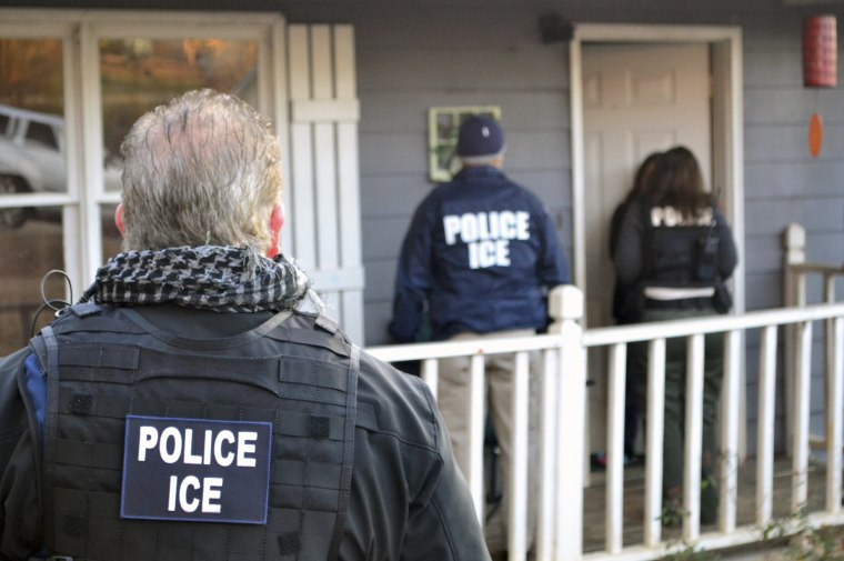 In this Feb. 9, 2017, photo provided U.S. Immigration and Customs Enforcement, ICE agents at a home in Atlanta, during a targeted enforcement operation aimed at immigration fugitives, re-entrants and at-large criminal aliens.