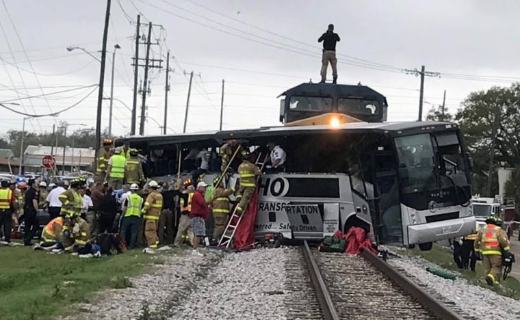 Image: Biloxi firefighters help passengers of a charter bus out after the bus collided with a train in Biloxi