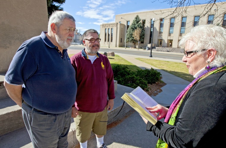 In this Oct. 21, 2014, file photo, Marvin Witt, left, and Mike Romero are married by nondenominational chaplain Pamela RW Kandt in downtown Casper, Wyo. The Wyoming Supreme Court has decided to censure but not remove a Pinedale judge who says her religious beliefs prevent her from presiding over same-sex marriages.