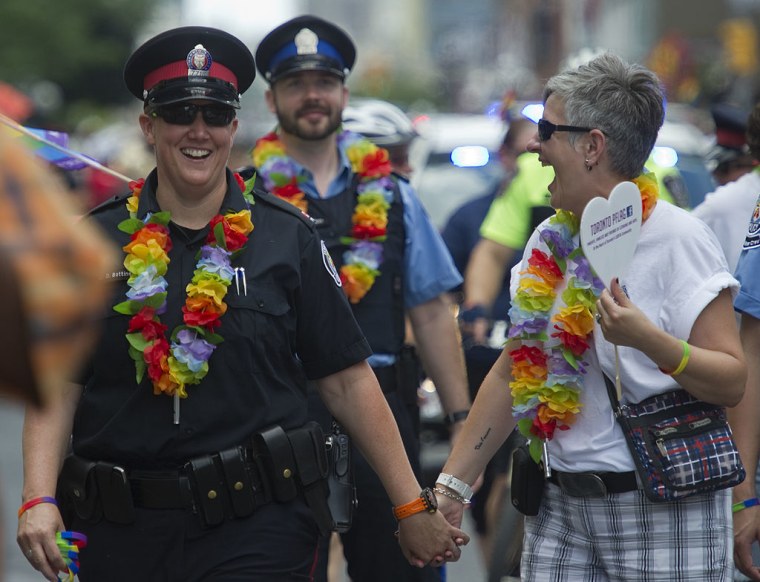 12-07-01 - TORONTO, ONTARIO - TPS Constable Danielle Bottineau (left) and wife Karin Dafont, walk ha