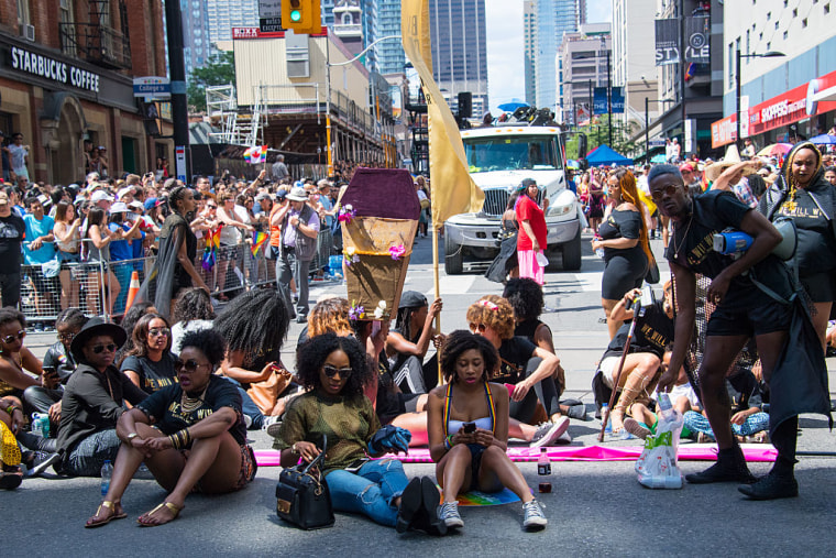 Members of Black Lives Matter sit and block the Toronto Pride Parade from the normal parade route on July 3, 2016.