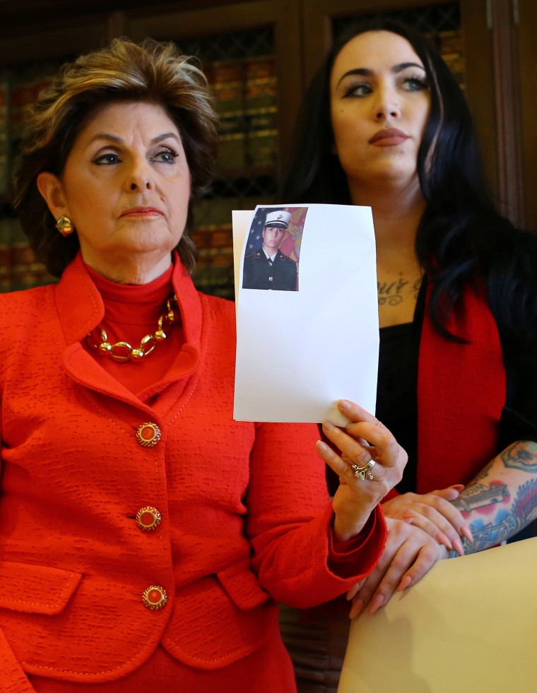 Image: Attorney Gloria Allred holds photograph with U.S. marine Erika Butner