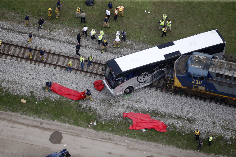 Image: Responders work the scene where a train hit a bus in Biloxi, Miss.
