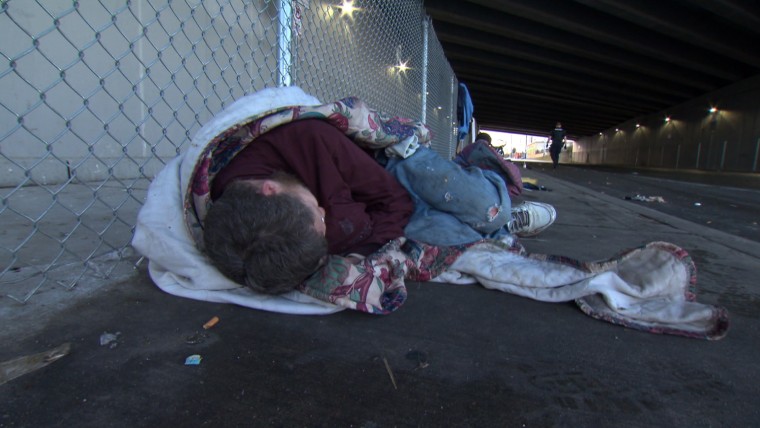 Image: A homeless person lays in the street in Everett, Wash.