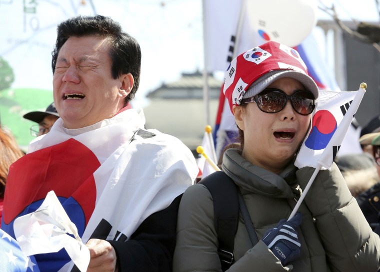 Image: Supporters of South Korean President Park Geun-hye cry during a rally opposing her impeachment