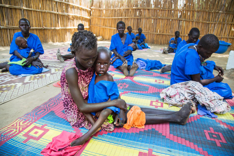 Image: Moms hold malnourished children in South Sudan