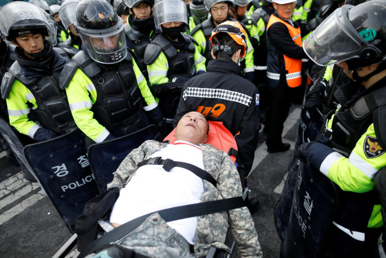 Image: A supporter of impeached President Park Geun-hye is wheeled on a stretcher during a protest after Park's impeachment was accepted.