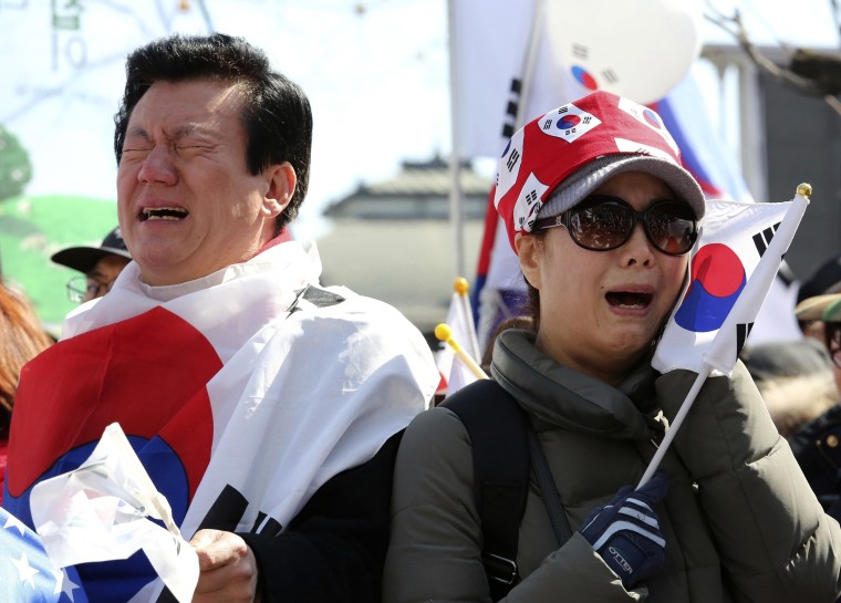 Image: Supporters of the president cry during a rally opposing her historical impeachment-- the first in South Korea's history.