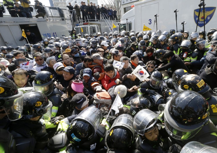 Image: Supporters of president are blocked by police officers as they march toward Constitutional Court.