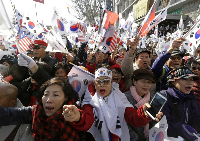 Image: Supporters of South Korean President Park Geun-hye shout slogans during a rally opposing her impeachment.