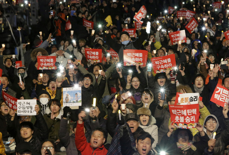 Image: Protesters shout slogans during a rally calling for impeached President Park Geun-hye's arrest.