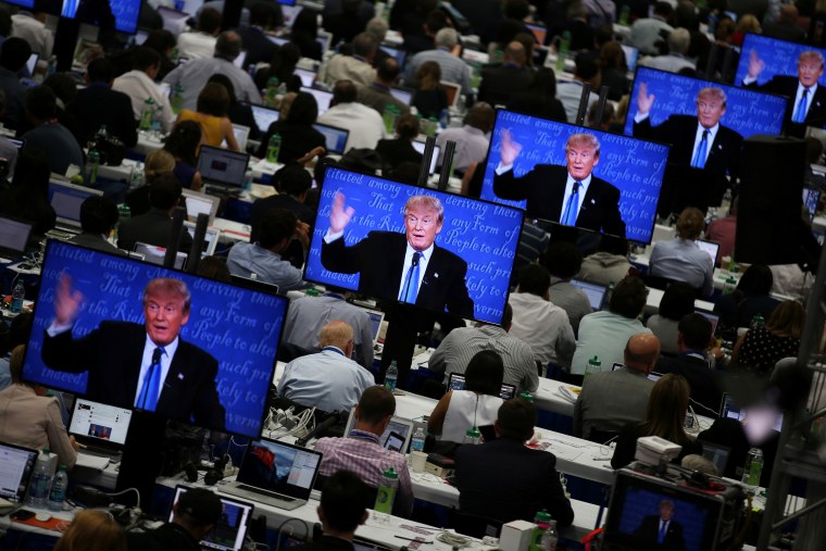 Image: Trump appears on television screens in the media room during the first presidential debate
