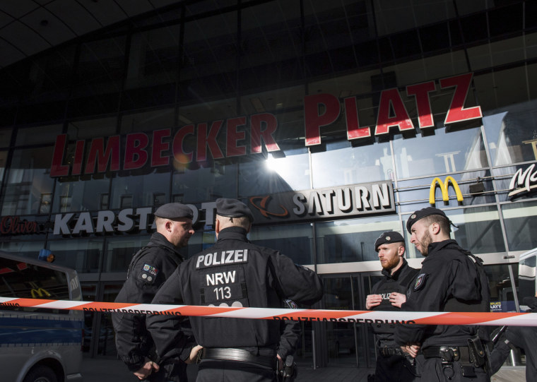 Image: Policemen guard the front of a shopping mall