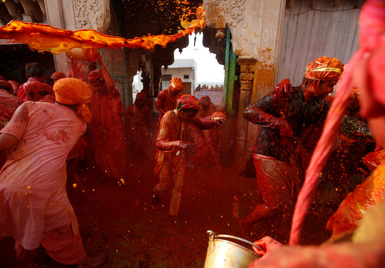 Image: Hindu devotees take part in the religious festival of Holi in Nandgaon village
