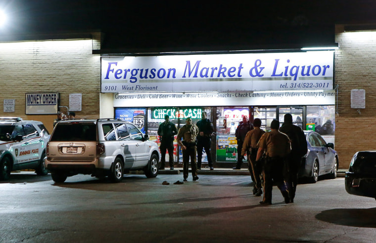 Image: Police line up in front of the Ferguson Market &amp; Liquor during a protest in Ferguson