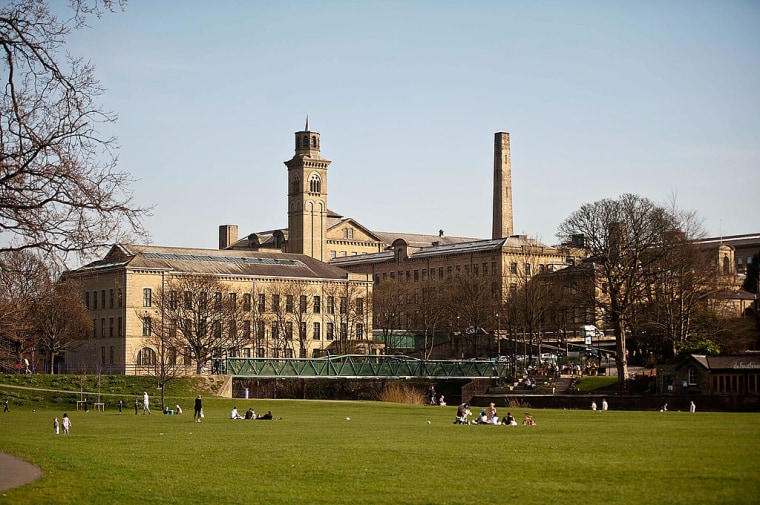 Visitors Enjoy The UNESCO World Heritage Site Of Saltaire
