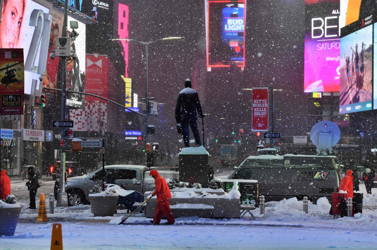Image: Men plow snow in Times Square