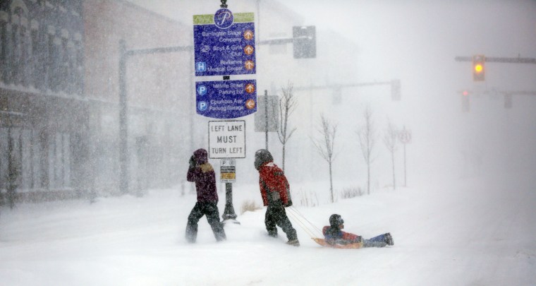 Image: People make their way through the snow-filled streets of Pittsfield, Mass.