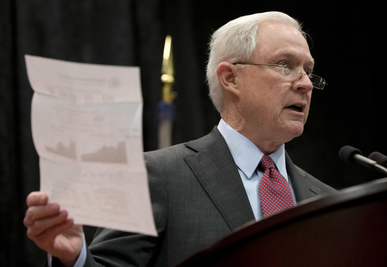 Image: Sessions holds a report on crime statistics during a speech before law enforcement officers in Richmond, Va.