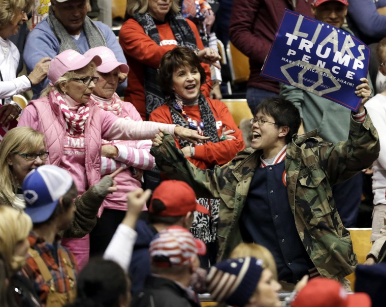 Image: A protester yells during a speech by President Donald Trump at a rally