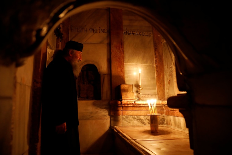 Image: A Greek Orthodox priest stands inside the newly restored Edicule at the Church of the Holy Sepulchre in Jerusalem's Old City