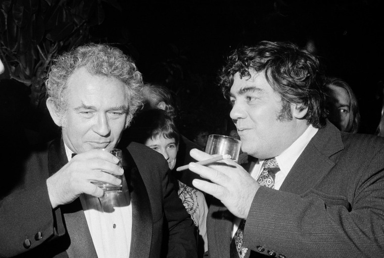 Author Norman Mailer, left, shares a drink with newspaper columnist Jimmy Breslin at the Four Seasons restaurant in New York during a 50th birthday celebration for Mailer in 1973.