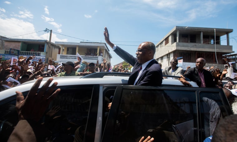 Image: Former Haitian President Jean-Bertrand Aristide greets supporters