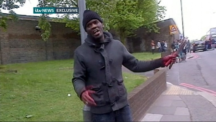 Image: Still image of Adebolajo showing a bloodied hand and knives following the murder of soldier Rigby in Woolwich