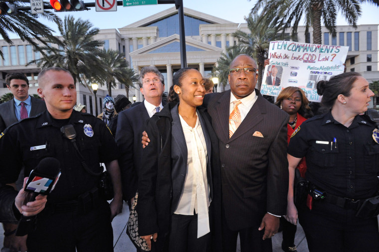 Marissa Alexander walks with her dad Raoul Jenkins after her sentencing in Jacksonville on Jan. 27, 2015.