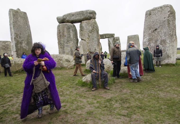 Image: A druid prays in the inner circle of Stonehenge
