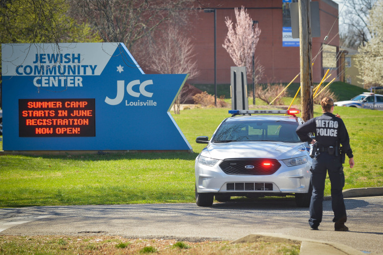 Image: A police officer blocks an entrance as officials respond to a bomb threat at the Jewish Community Center in Louisville