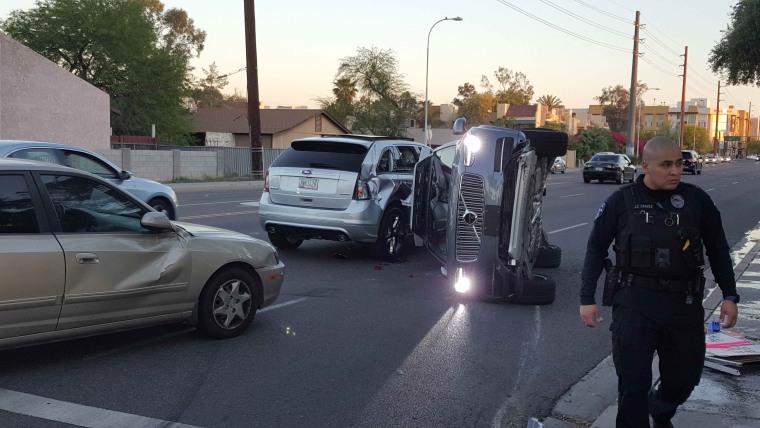 Image: A self-driven Volvo SUV owned and operated by Uber Technologies Inc. is flipped on its side after a collision in Tempe