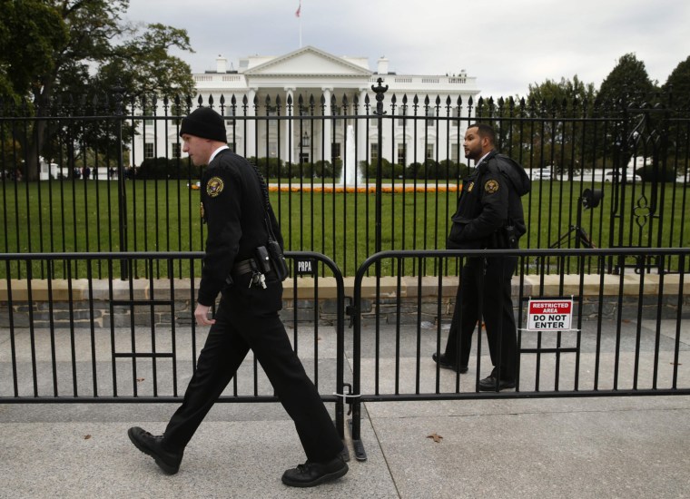 Image: Members of the U.S. Secret Service patrol in front of the North Lawn of the White House in Washington