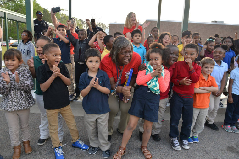 Students react to their surprise Thursday.