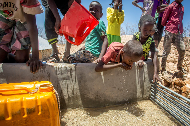 Image: Children drink water delivered by a truck in the drought-stricken Baligubadle village in this handout provided by The International Federation of Red Cross and Red Crescent Societies on March 15.