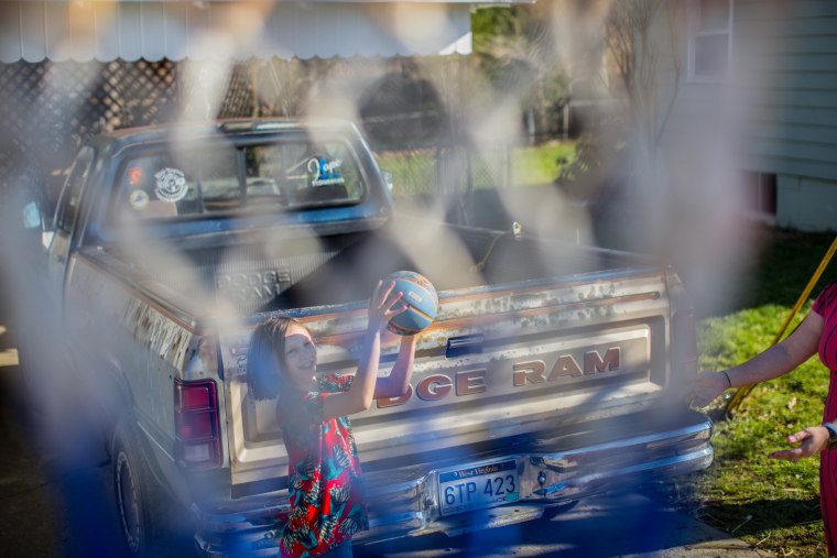 Image: Gabriella Corley shoots a basketball in the driveway of her home