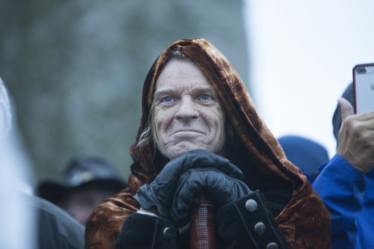 Image: A druid participates in a ceremony at Stonehenge