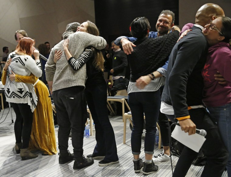 Image: Attendees embrace during an alcohol-free social evening sponsored by The Shine at a hotel in Williamsburg, Brooklyn on March 8, 2017