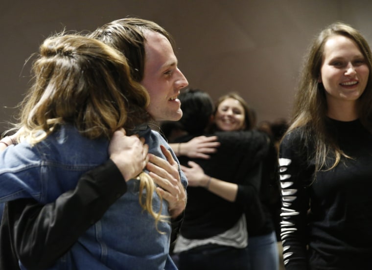 Image: Attendees embrace during an alcohol-free social evening sponsored by The Shine at a hotel in Williamsburg, Brooklyn on March 8, 2017