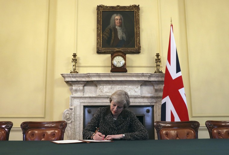 Image: Britain's Prime Minister Theresa May signs the official letter to European Council President Donald Tusk