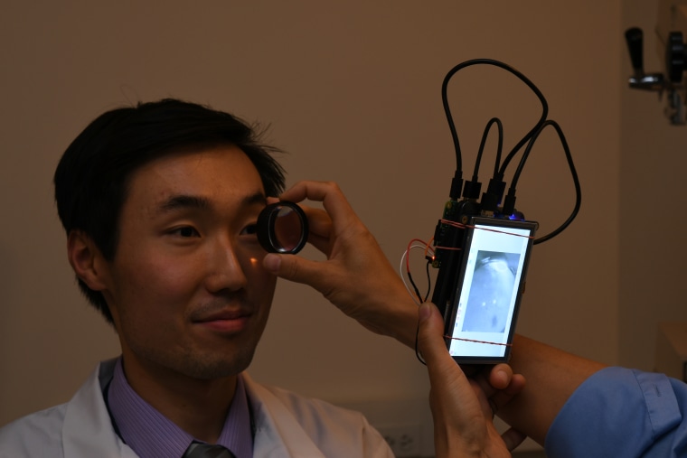 Dr. Bailey Shen has his retina photographed by the portable camera.