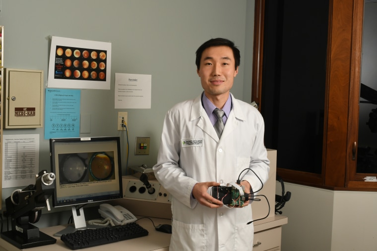 Dr. Bailey Shen holds his new prototype, which weighs less than a pound.