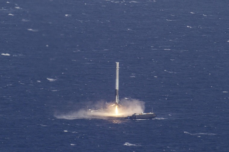 Image: Handout photo of the reusable main-stage booster from the SpaceX Falcon 9 makes a successful landing on a platform in the Atlantic Ocean about 185 Nautical miles off the coast of Florida