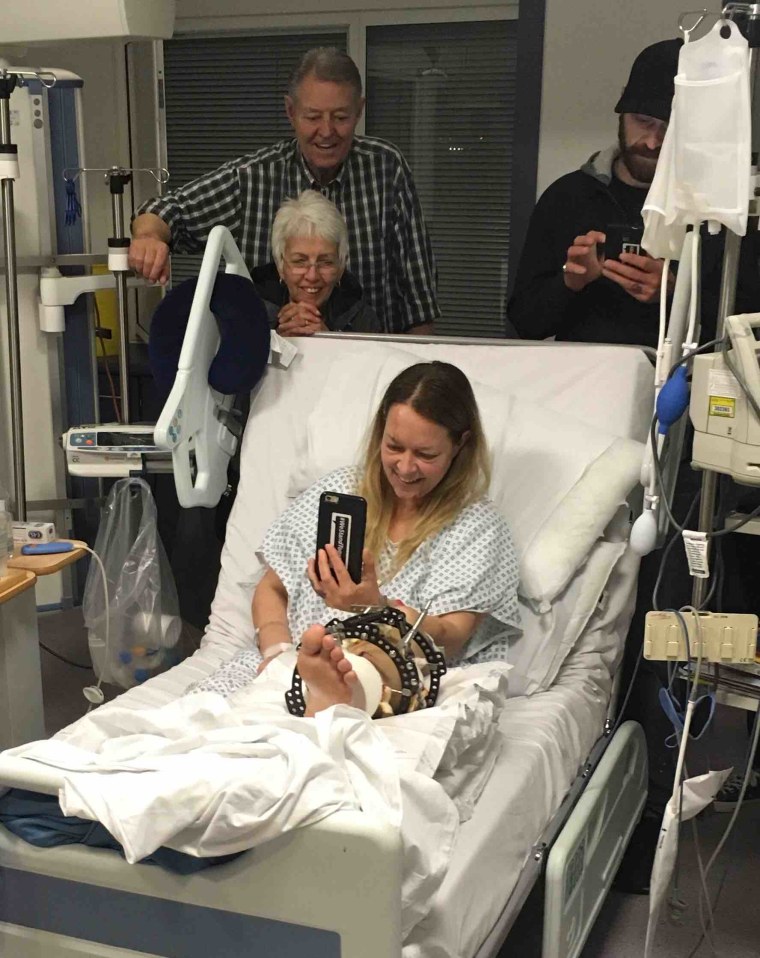 Image: Melissa Cochran talks on the phone from her hospital room