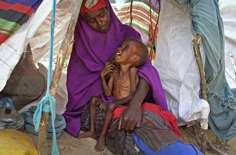 Image: newly displaced Somali mother Sahra Muse, 32, comforts her malnourished child Ibrahim Ali