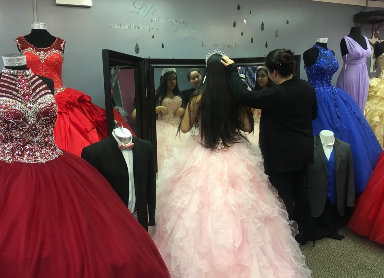 A quincea?era tries on dress and tiara in Little Village, Chicago.