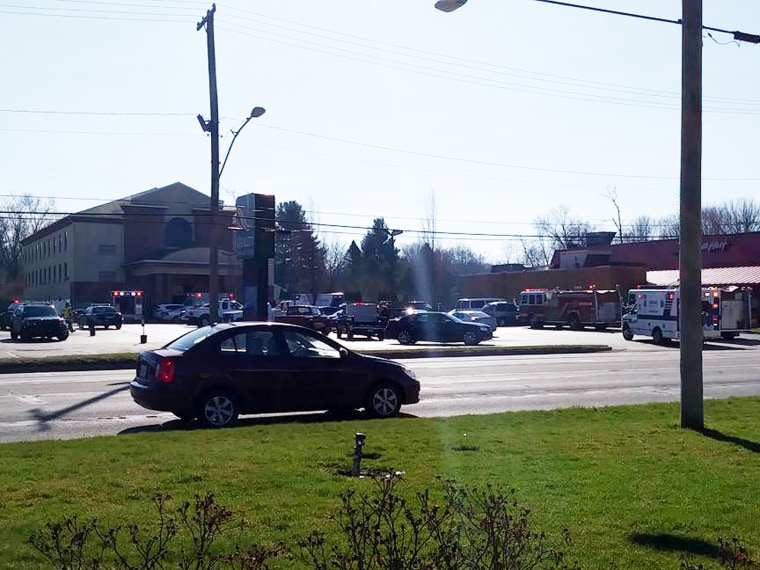 Image: Fire trucks and ambulances line the parking lot in front of a Niles, Michigan Quality Inn, where a Carbon Monoxide leak has killed at least one person and injured 12 more.