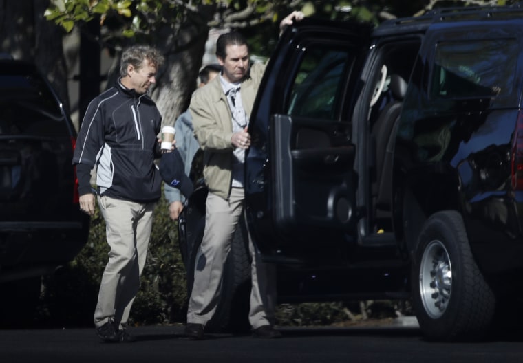 Image: A Secret Service agent opens the door of the presidential vehicle for Sen. Rand Paul, R-Ky, left, on the South Lawn driveway at the White House in Washington, April 2, 2017.